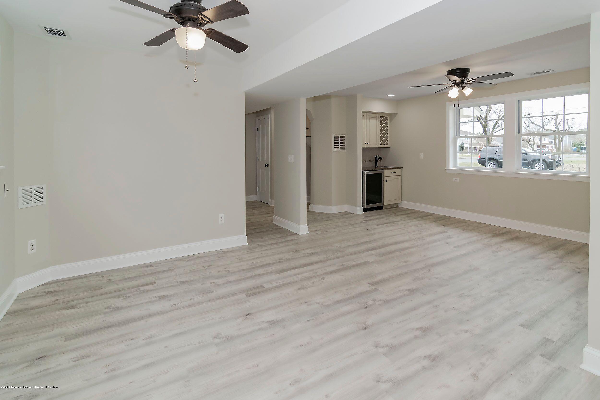 1521 Treeneedle Road Point Pleasant, NJ 08742 - Photo 10 of 33 wooden floor in an empty room with a window