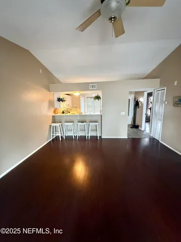a view of a room with wooden floor