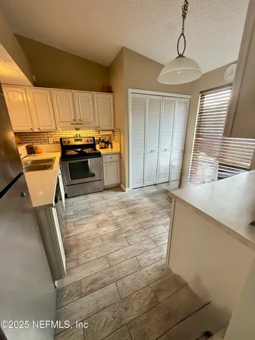 a kitchen with a sink and a stove top oven