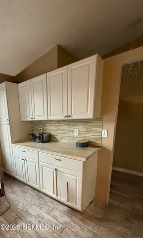 a kitchen with stainless steel appliances a sink a stove a refrigerator and cabinets