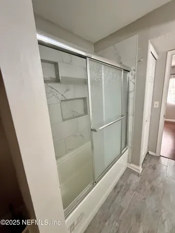 a bathroom with a glass door shower