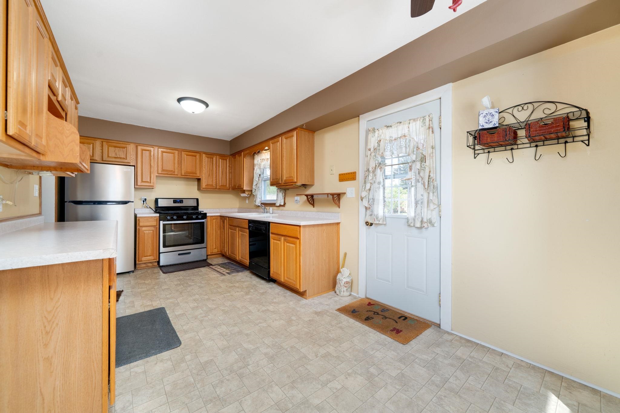 1611 Notre Dame Road Rockford, IL 61103 - Photo 7 of 33 a kitchen with stainless steel appliances granite countertop a refrigerator and a stove top oven