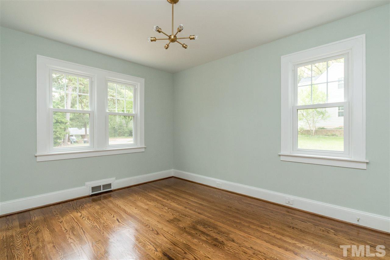2503 Mayview Road Raleigh, NC 27607 - Photo 14 of 20 a view of an empty room with wooden floor and a window