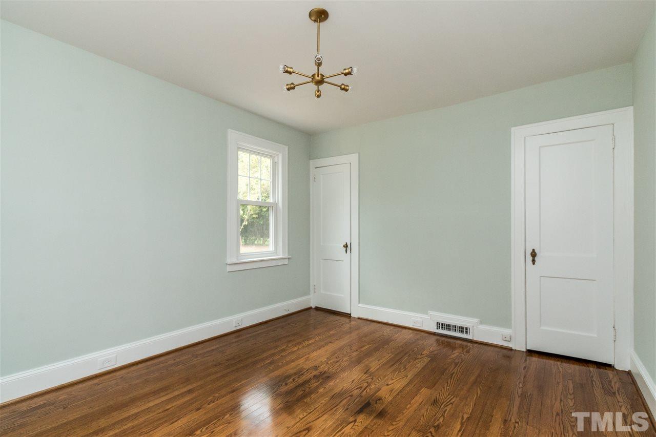 2503 Mayview Road Raleigh, NC 27607 - Photo 15 of 20 a view of an empty room with wooden floor and a window