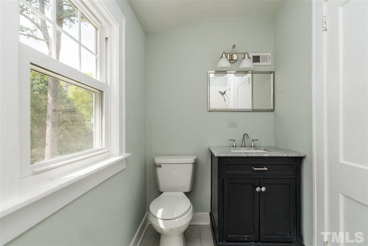 2503 Mayview Road Raleigh, NC 27607 - Photo 18 of 20 a bathroom with a toilet a sink a vanity and mirror