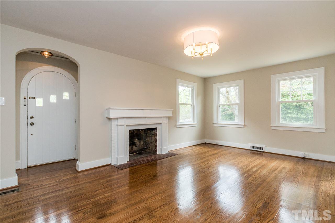 2503 Mayview Road Raleigh, NC 27607 - Photo 6 of 20 an empty room with wooden floor chandelier and windows