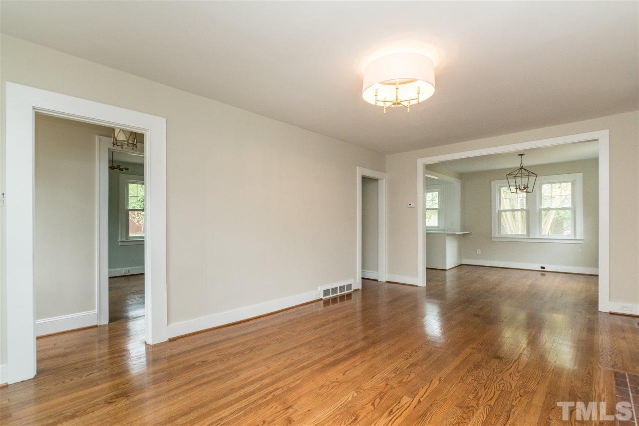 2503 Mayview Road Raleigh, NC 27607 - Photo 7 of 20 a view of an empty room with wooden floor and a window