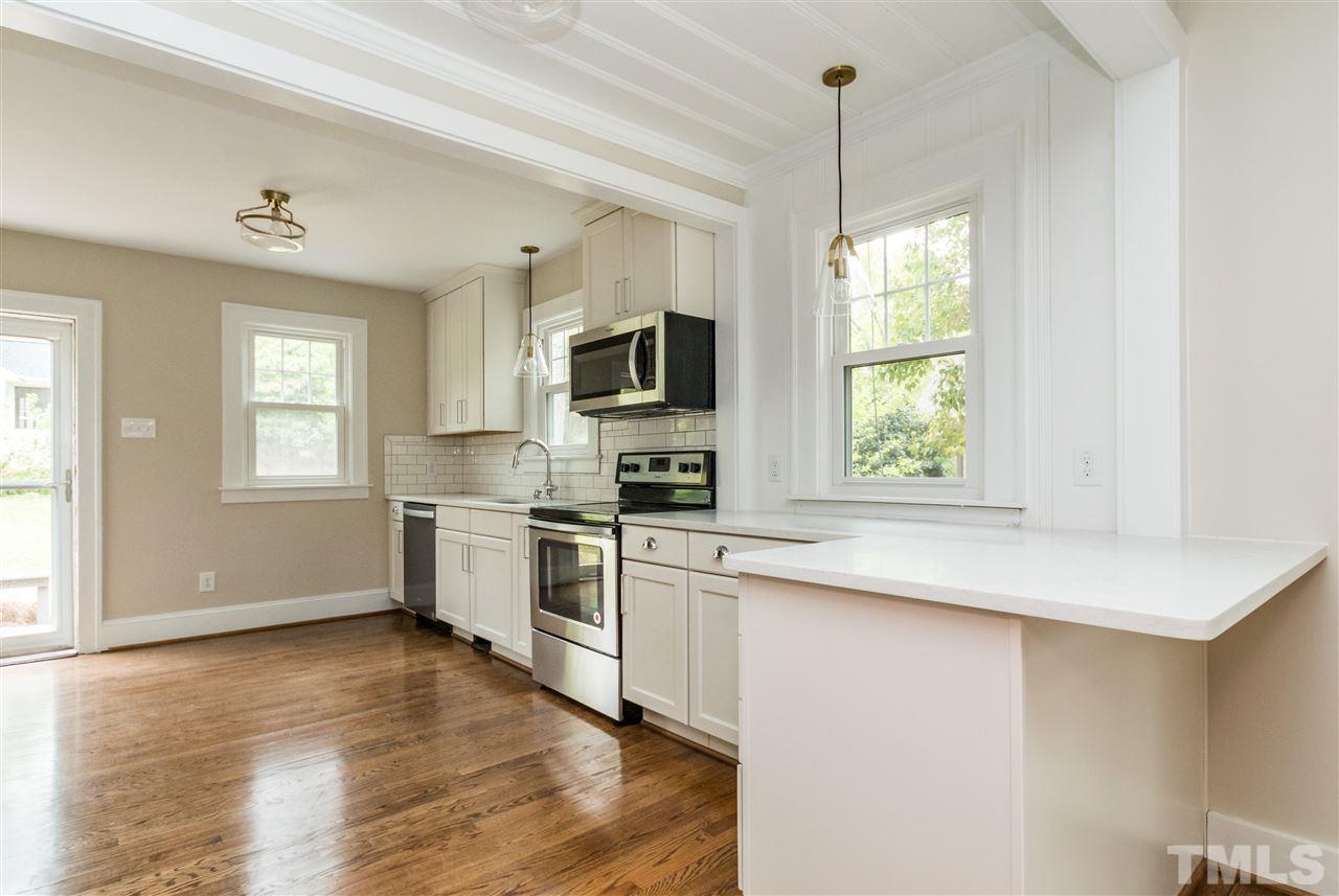2503 Mayview Road Raleigh, NC 27607 - Photo 10 of 20 a kitchen with a window a sink and stainless steel appliances