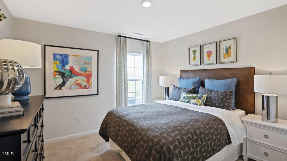 5917 Sodium Street Raleigh, NC 27610 - Photo 20 of 24 a bedroom with a bed and painting on the wall