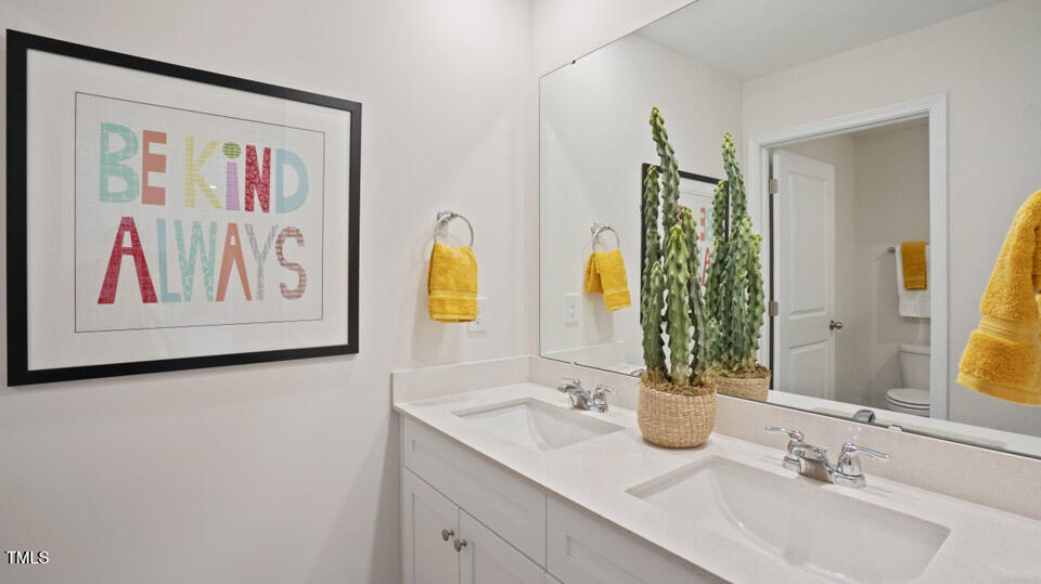 5917 Sodium Street Raleigh, NC 27610 - Photo 4 of 24 a bathroom with a granite countertop sink and a mirror