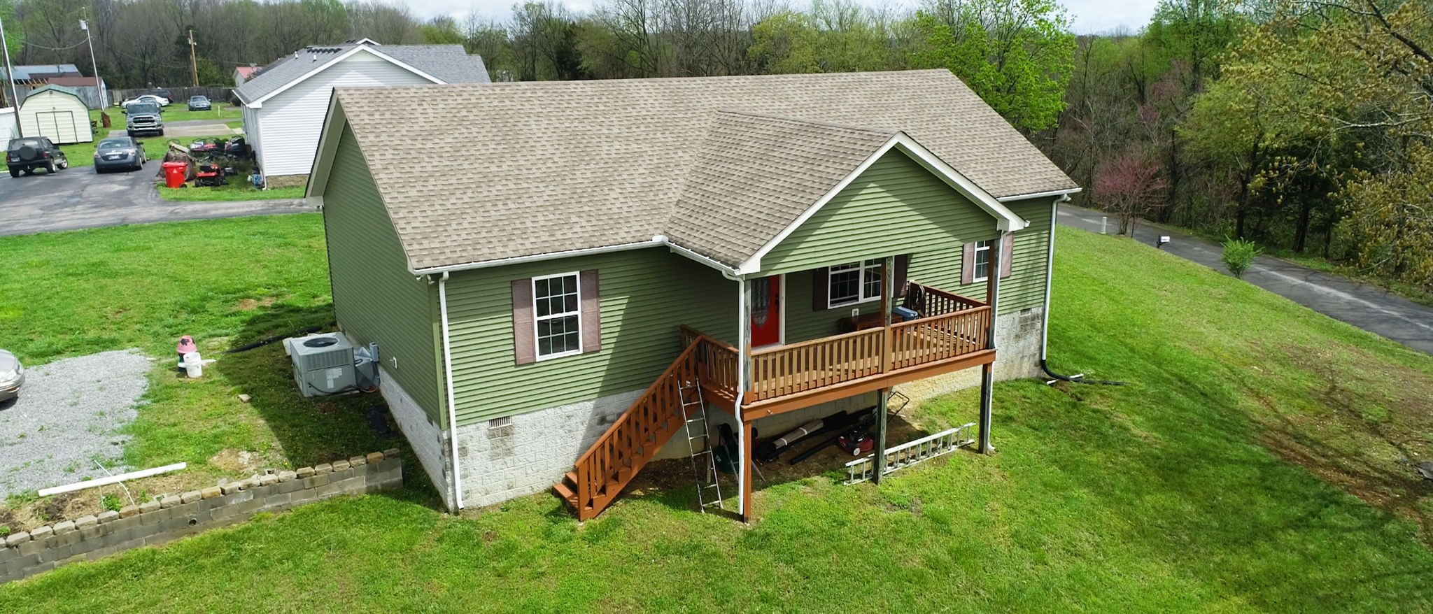 a aerial view of a house with a yard and sitting area