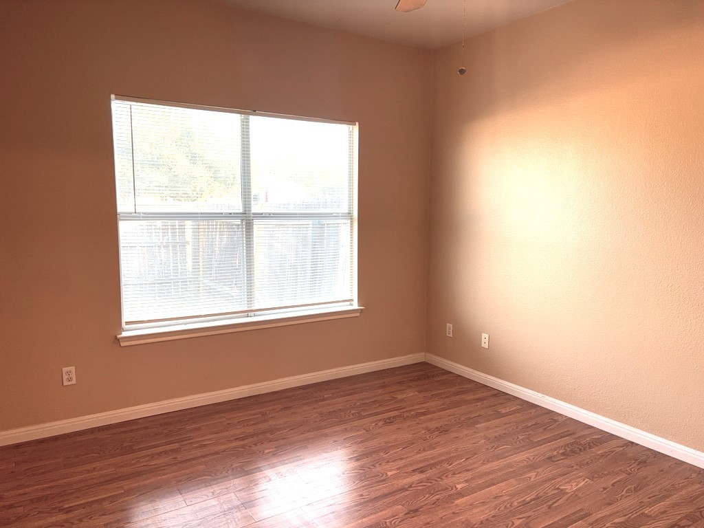 2869 Southampton Way, Unit B Round Rock, TX 78664 - Photo 12 of 19 Primary bedroom with windows overlooking the backyard.
