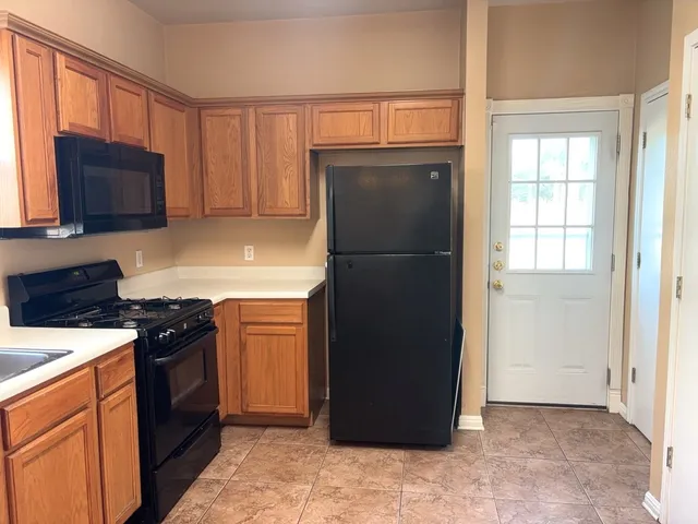 a kitchen with a refrigerator stove and sink