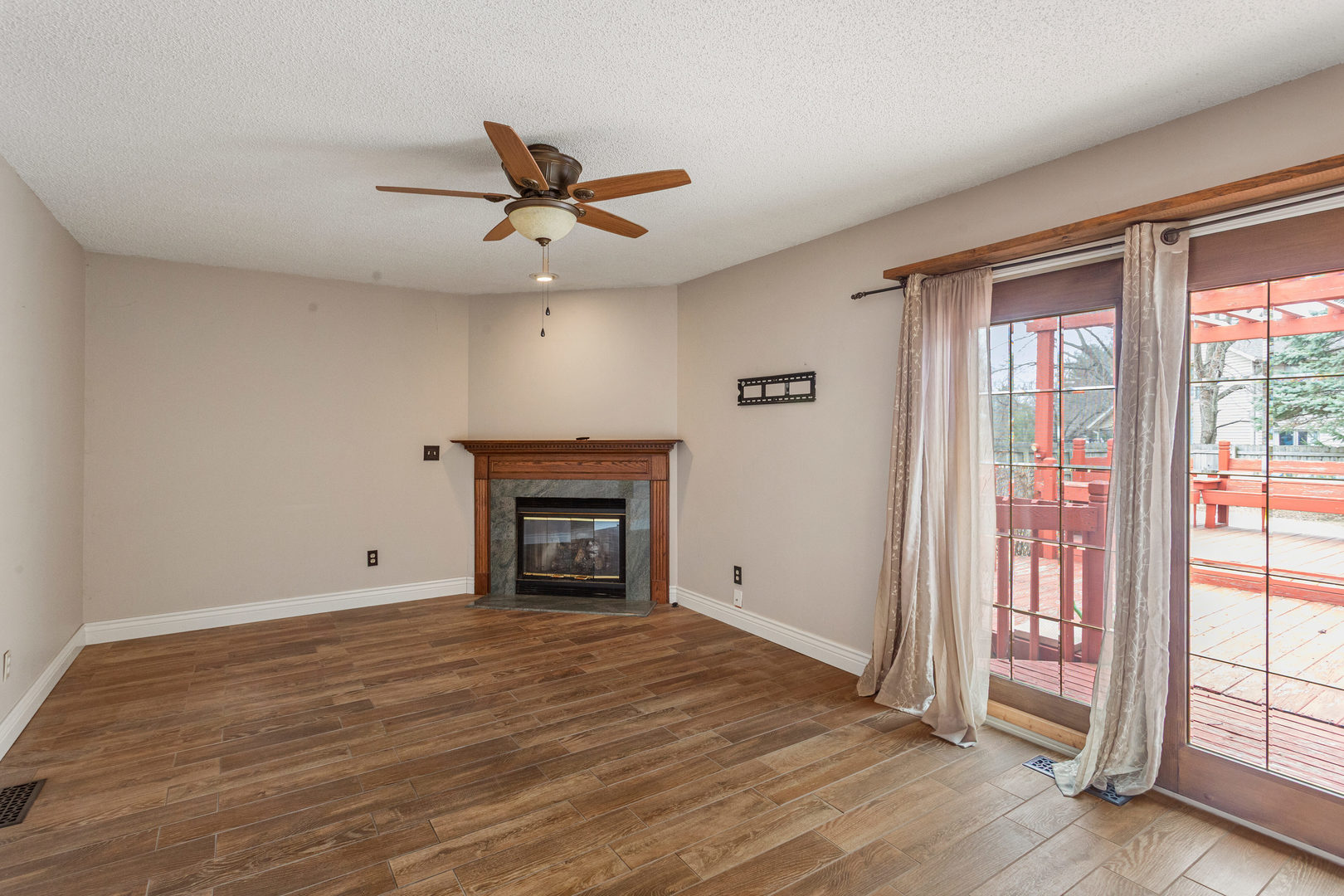 2211 Carlisle Drive Champaign, IL 61821 - Photo 14 of 34 an empty room with wooden floor fan and windows