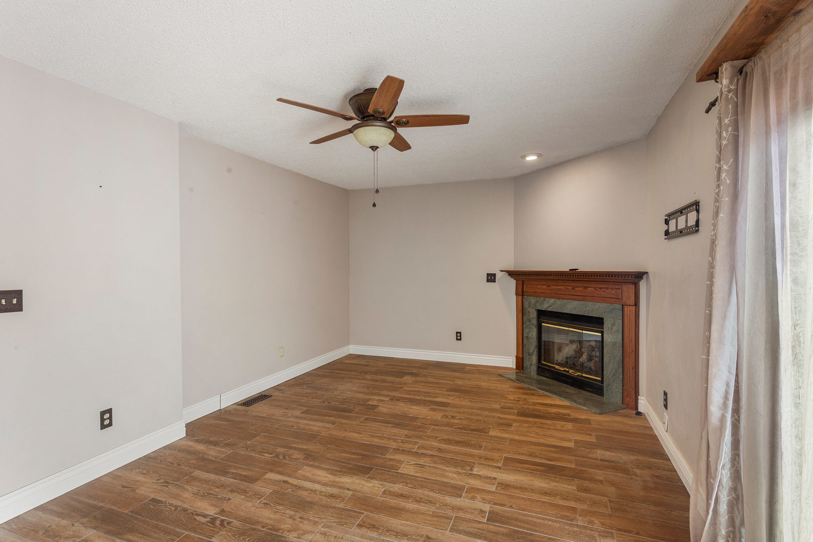 2211 Carlisle Drive Champaign, IL 61821 - Photo 15 of 34 a view of empty room with wooden floor and fireplace