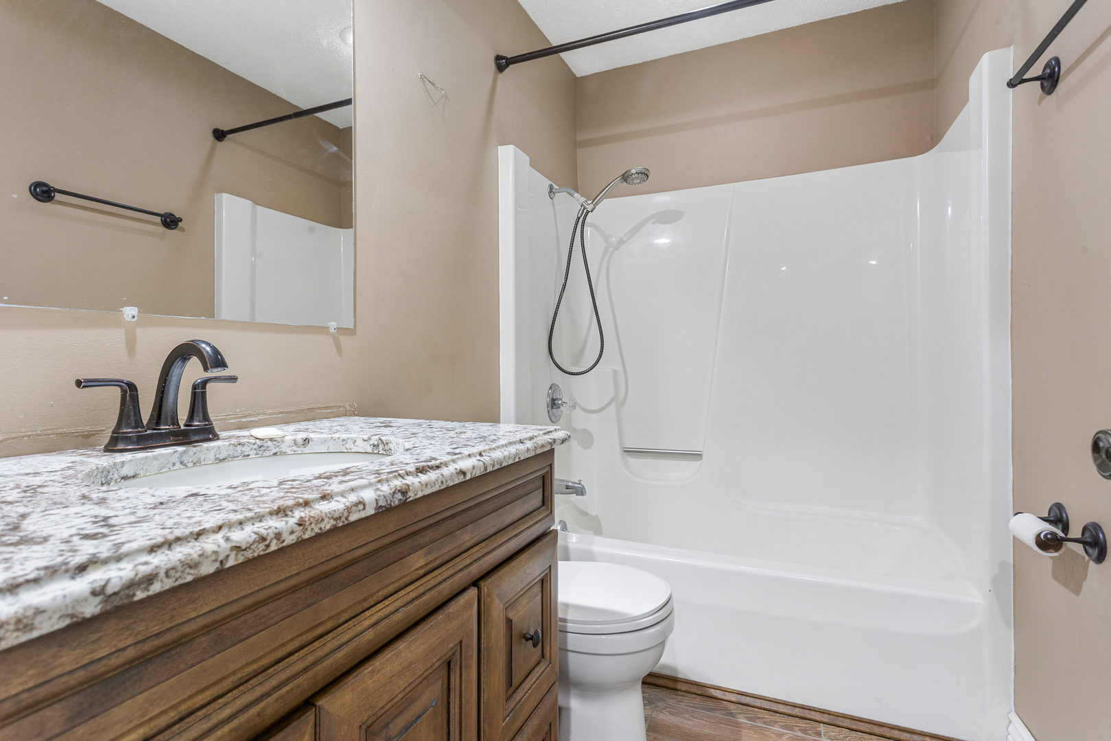 2211 Carlisle Drive Champaign, IL 61821 - Photo 17 of 34 a bathroom with a granite countertop sink a toilet and shower