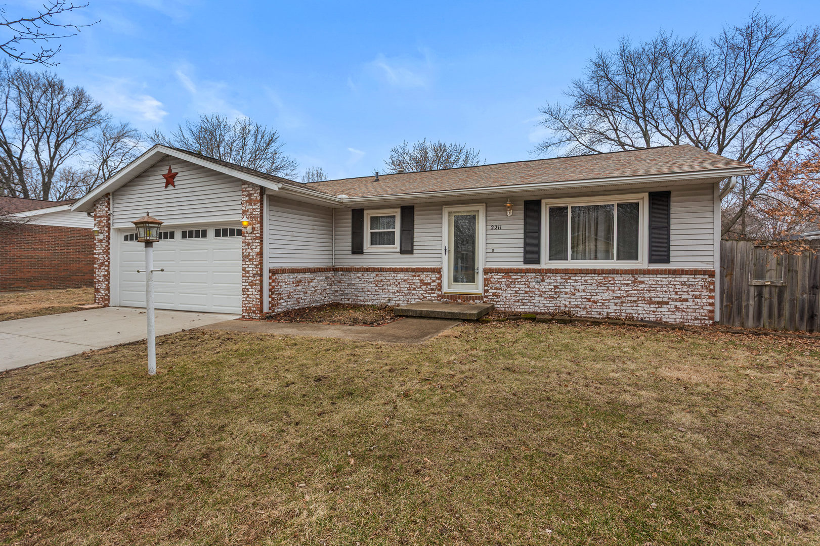 2211 Carlisle Drive Champaign, IL 61821 - Photo 2 of 34 a front view of a house with a yard and garage