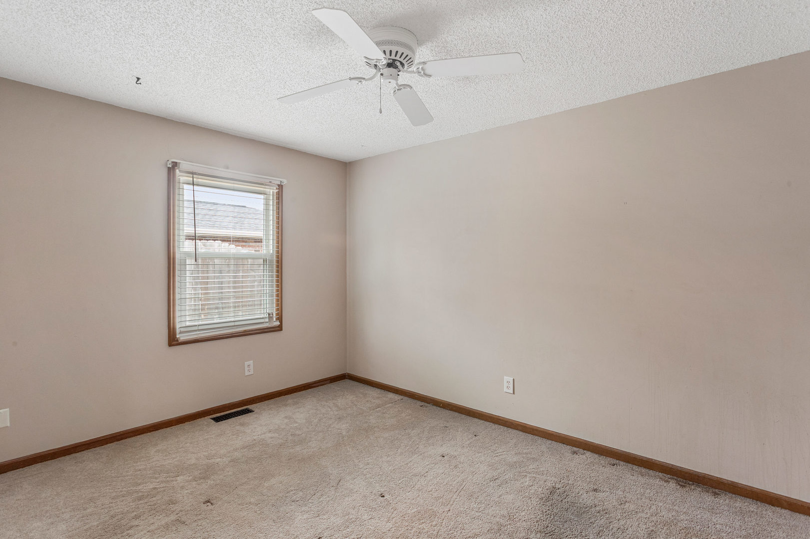 2211 Carlisle Drive Champaign, IL 61821 - Photo 21 of 34 an empty room with a window and a fan