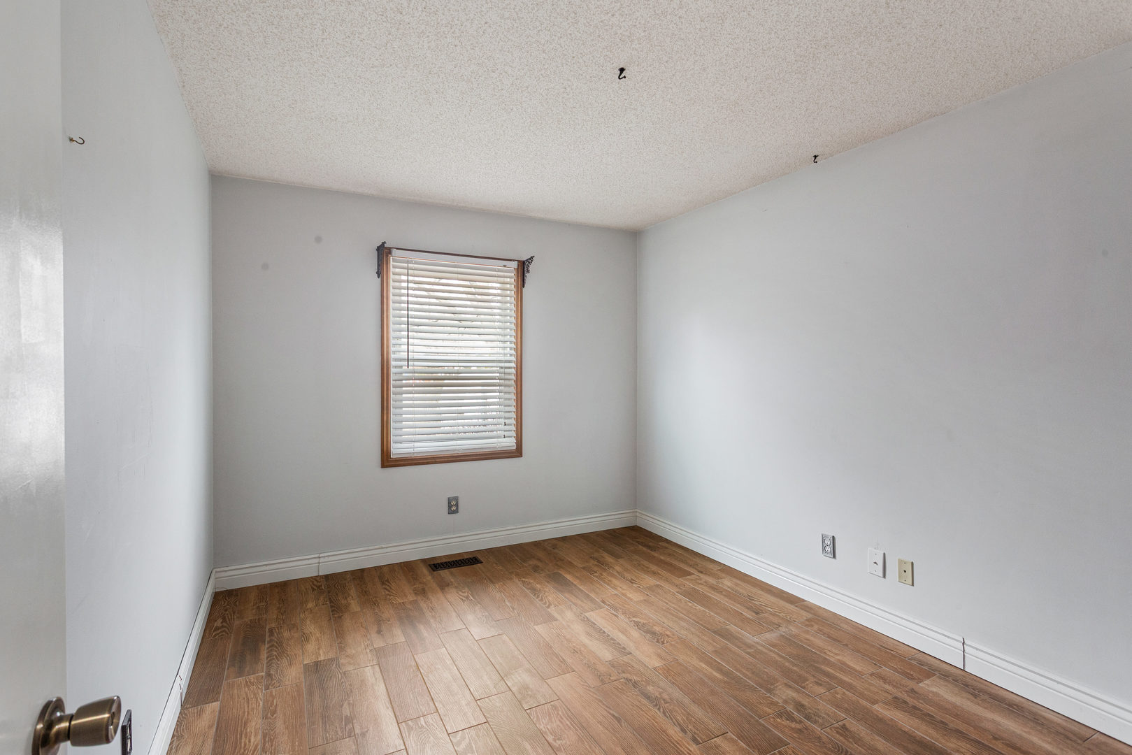 2211 Carlisle Drive Champaign, IL 61821 - Photo 23 of 34 wooden floor in an empty room with a window