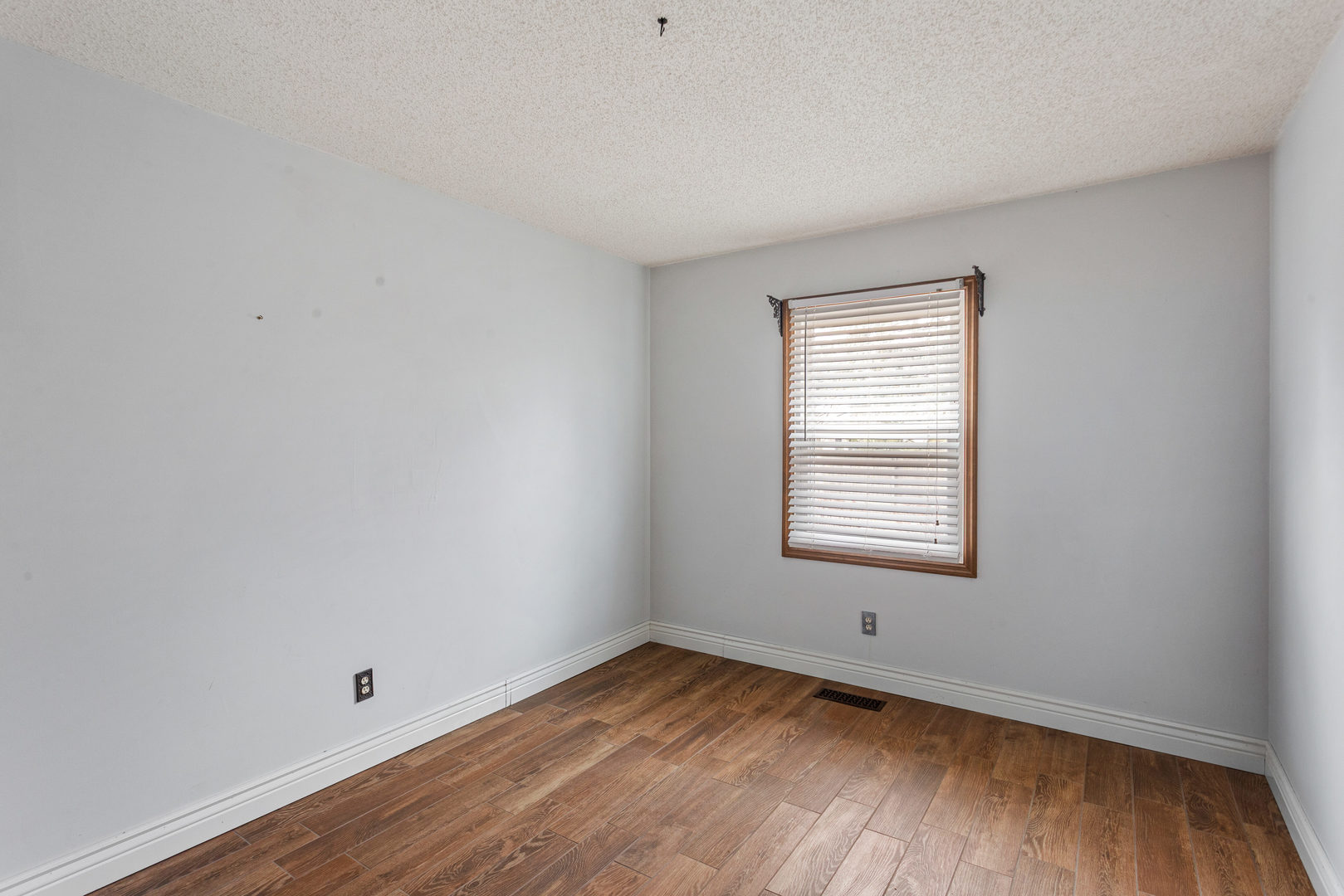 2211 Carlisle Drive Champaign, IL 61821 - Photo 24 of 34 a view of an empty room with wooden floor and a window