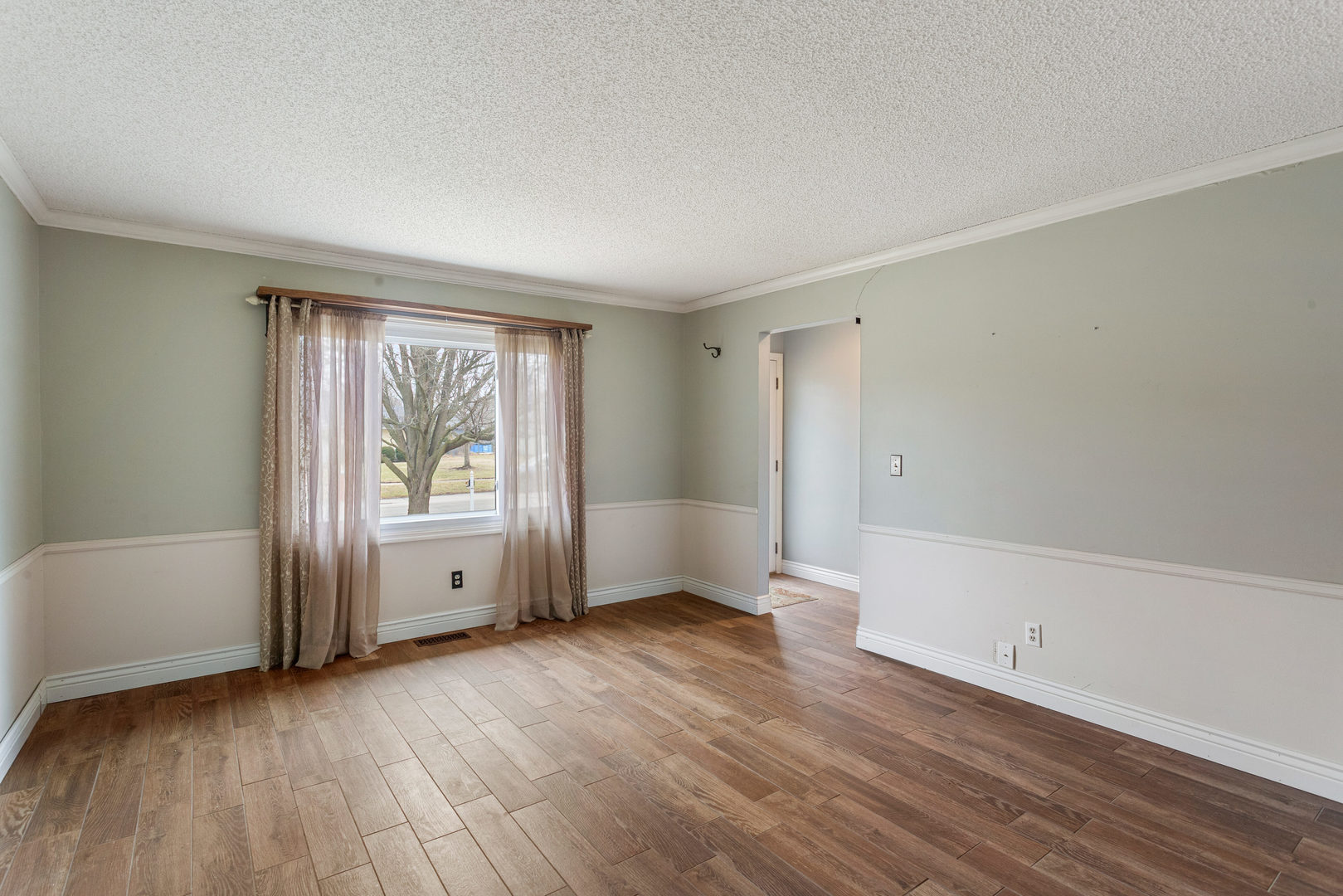 2211 Carlisle Drive Champaign, IL 61821 - Photo 5 of 34 an empty room with wooden floor and windows