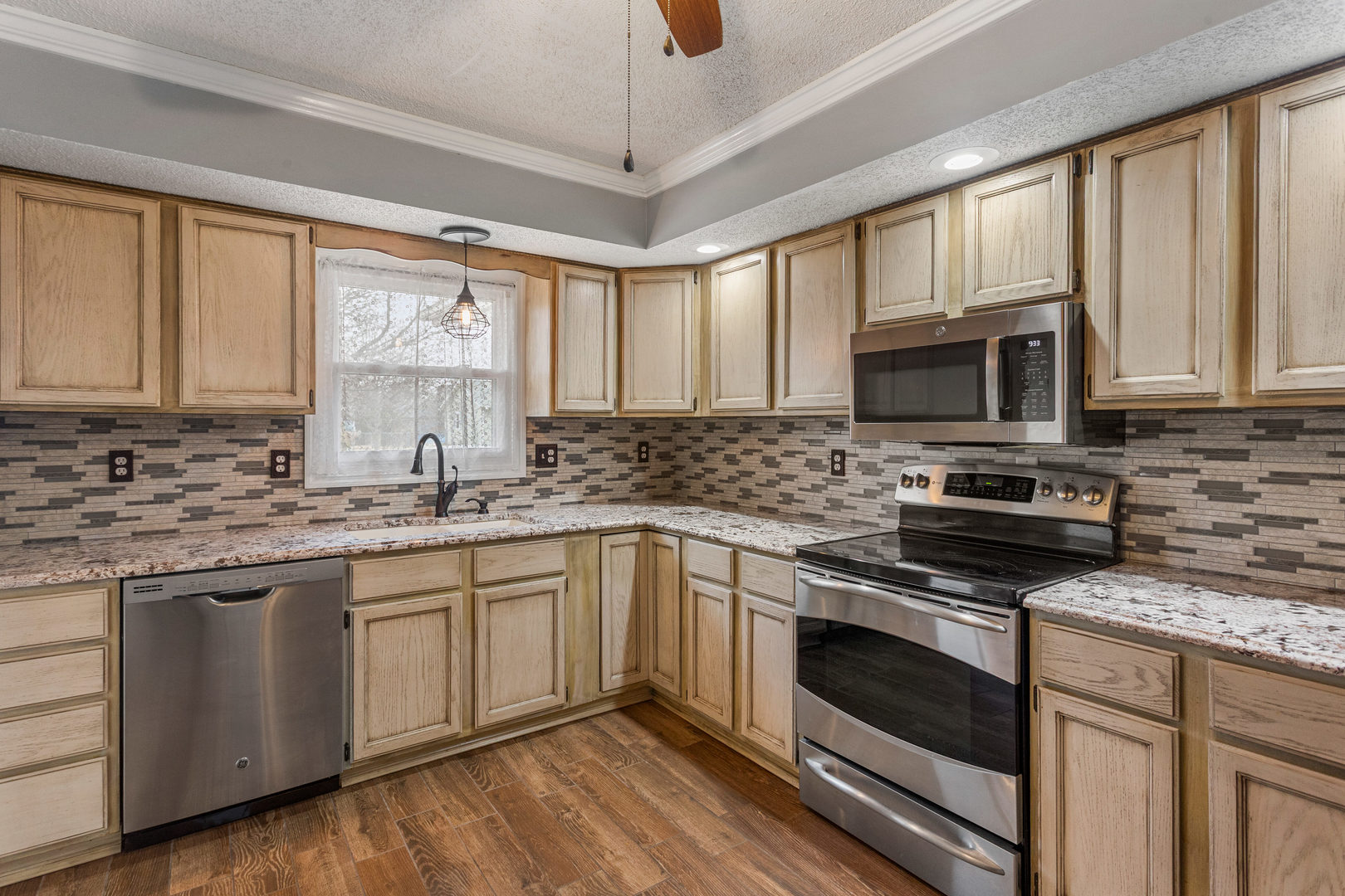 2211 Carlisle Drive Champaign, IL 61821 - Photo 9 of 34 a kitchen with granite countertop a stove sink microwave and cabinets