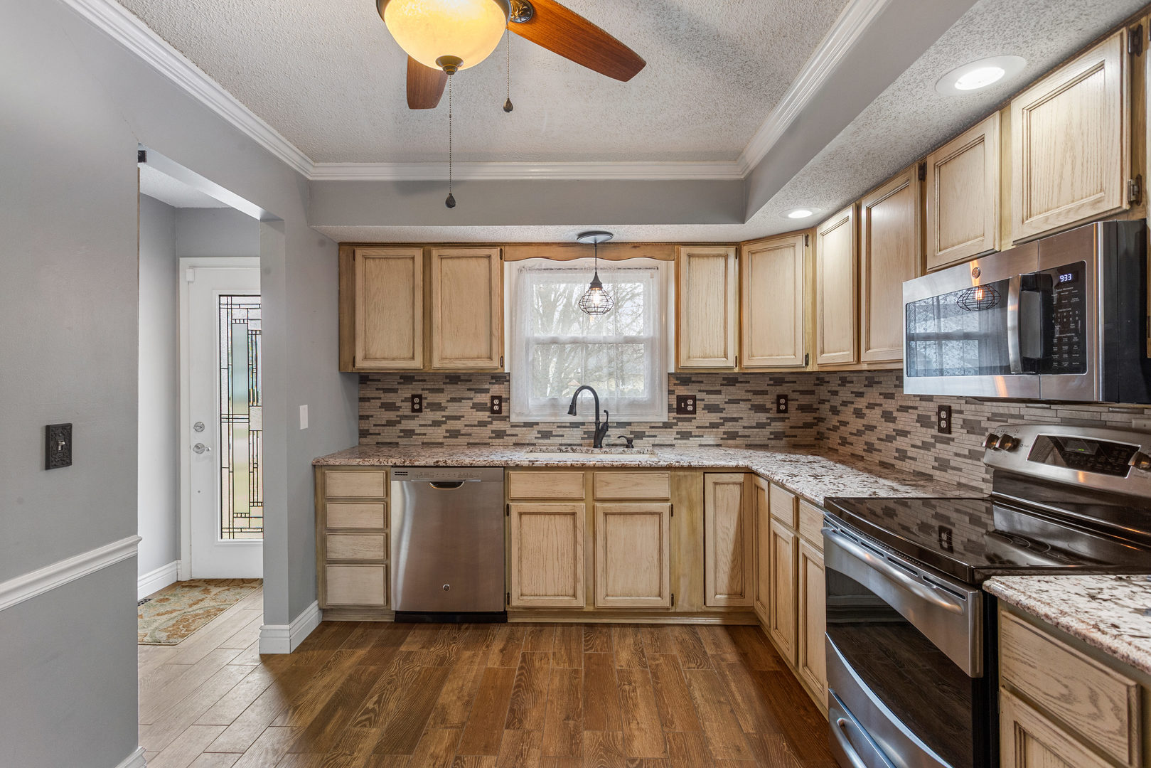 2211 Carlisle Drive Champaign, IL 61821 - Photo 10 of 34 a kitchen with stainless steel appliances granite countertop a sink and stove top oven