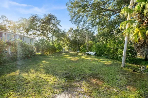 a view of a backyard with sitting area