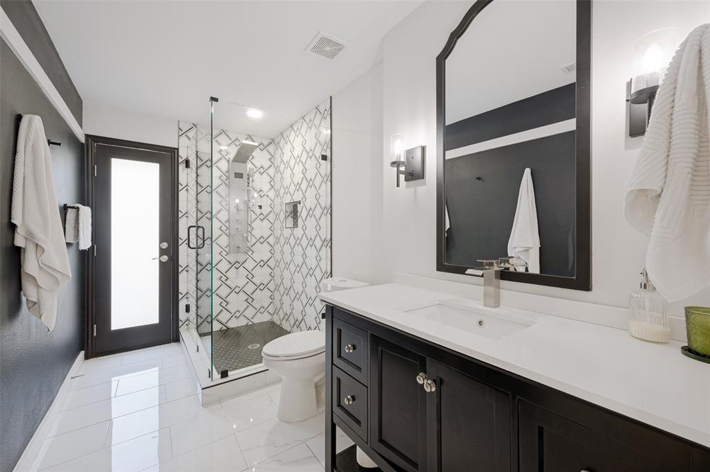 3619 Merrell Road Dallas, TX 75229 - Photo 19 of 26 Modern bathroom featuring a dark wood-finish vanity with a white countertop and undermount sink