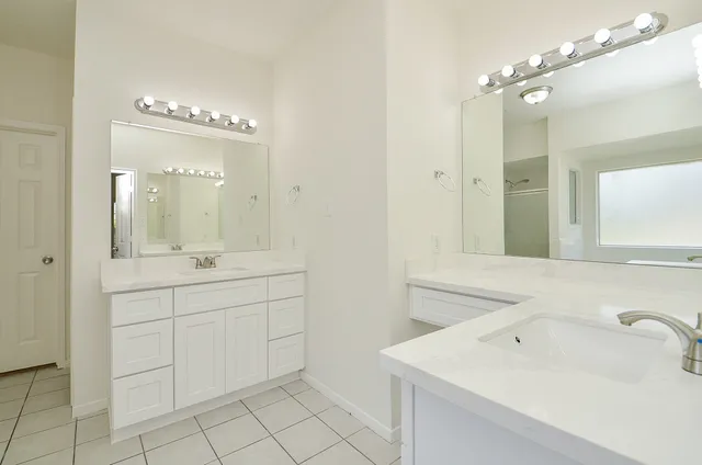 a spacious bathroom with a sink vanity and mirror