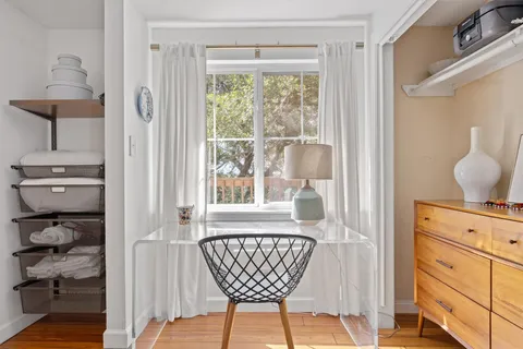 a room with a chandelier and a window