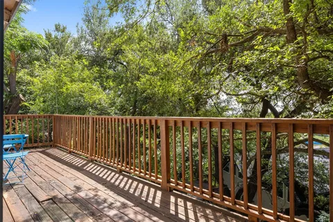 a view of balcony with wooden floor and outdoor seating