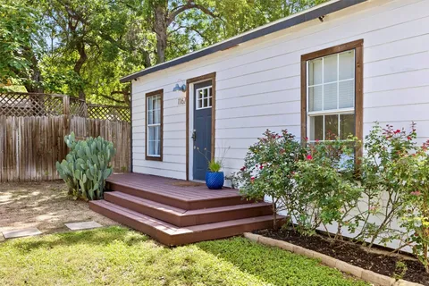 a wooden bench sitting in front of a house