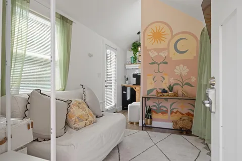 a bedroom with a bed and a mirror