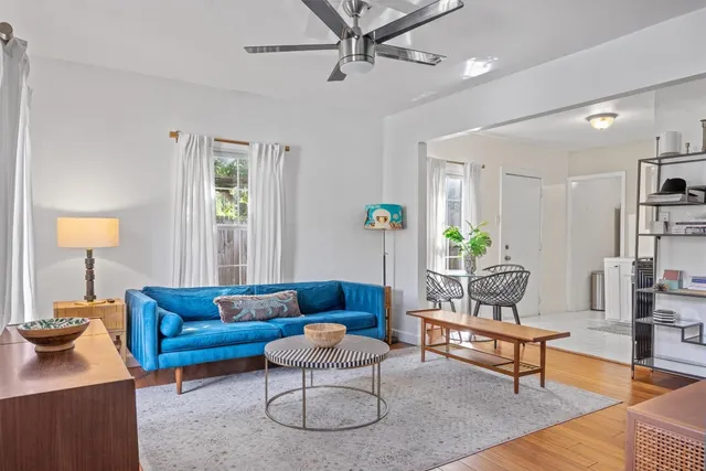 a living room with furniture and a lamp