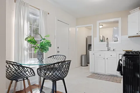 a dining room with furniture and wooden floor