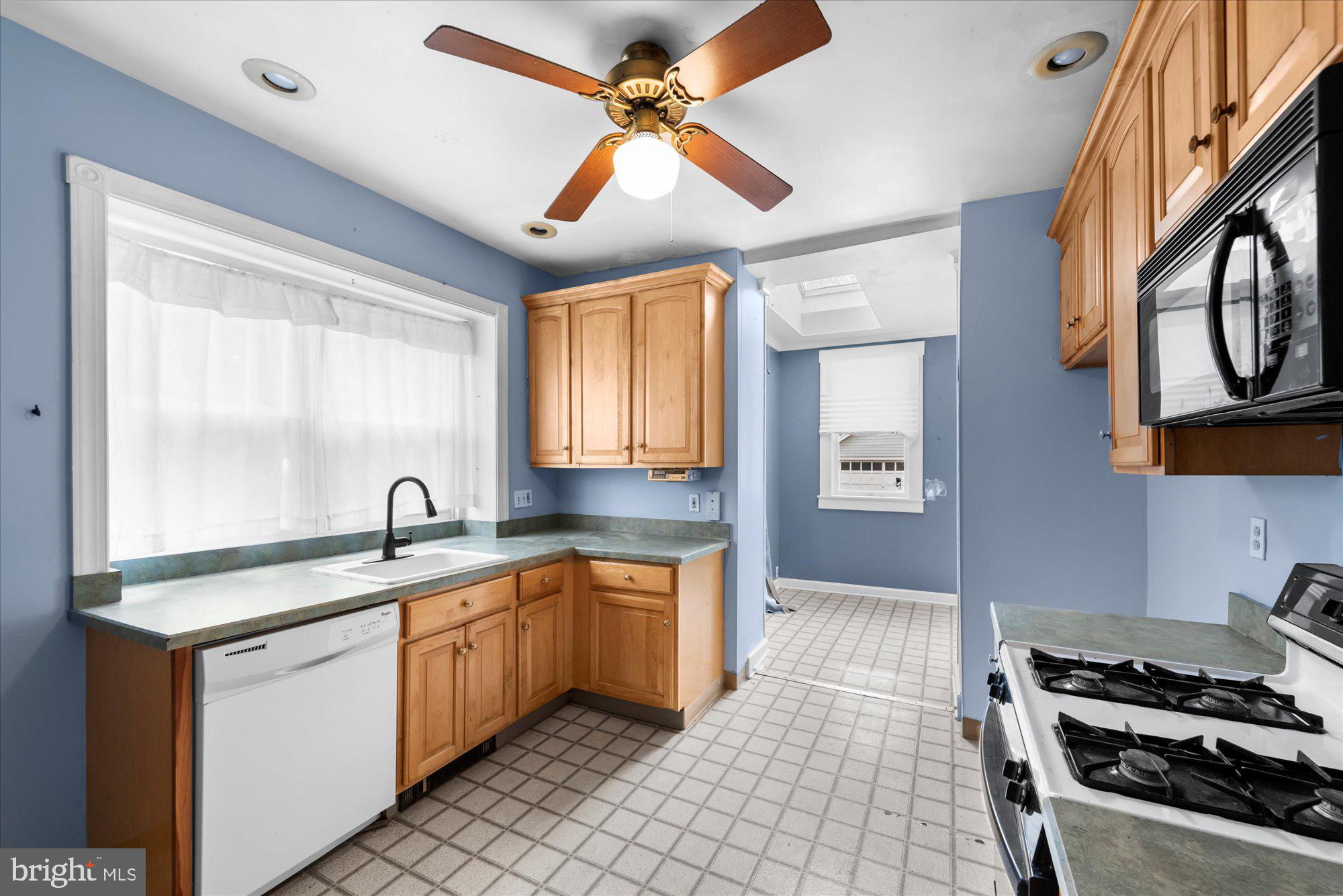 305 Lansdowne Road Havertown, PA 19083 - Photo 14 of 45 a kitchen with stainless steel appliances granite countertop a sink a stove and a window