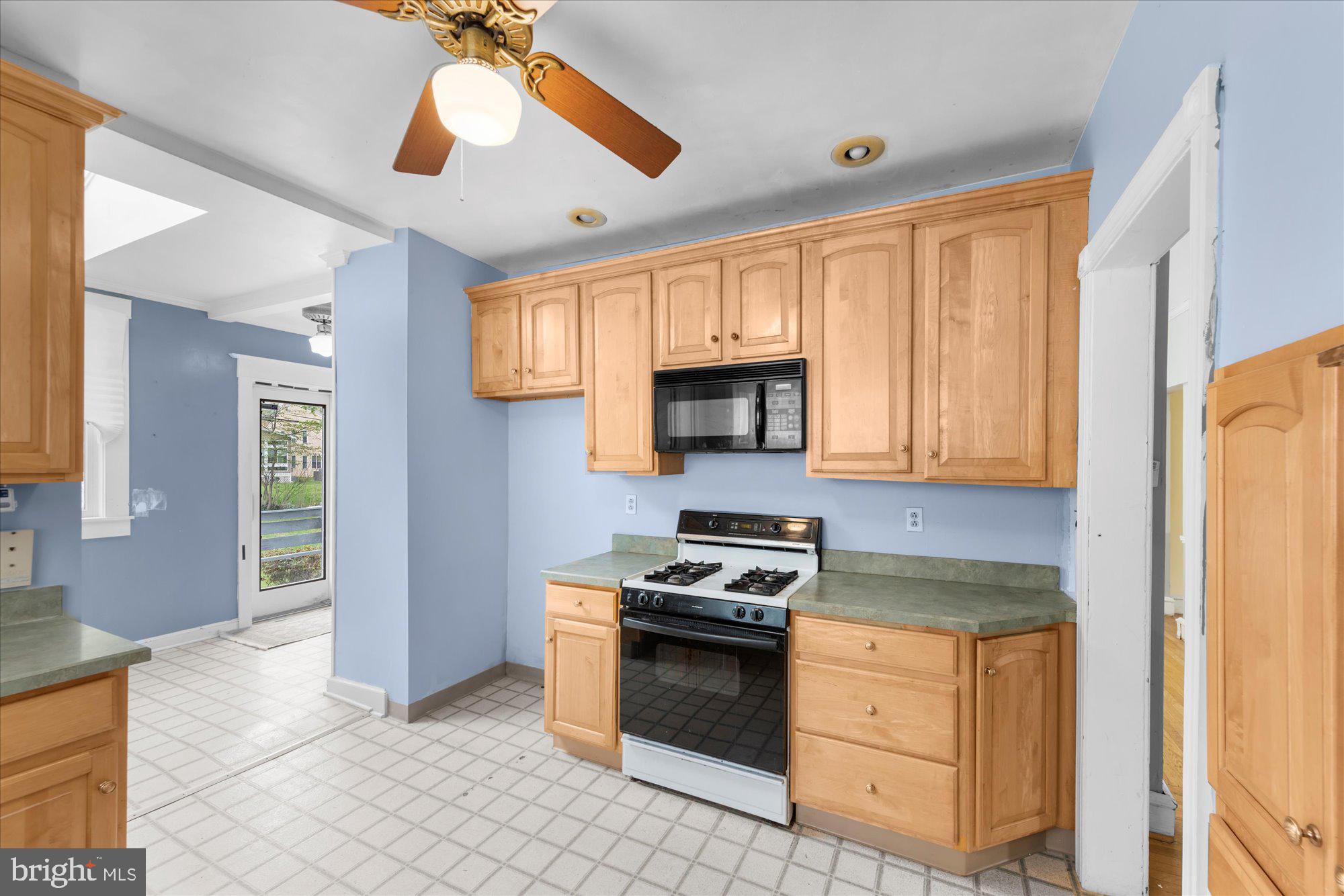 305 Lansdowne Road Havertown, PA 19083 - Photo 15 of 45 a kitchen with granite countertop a stove a sink and a refrigerator