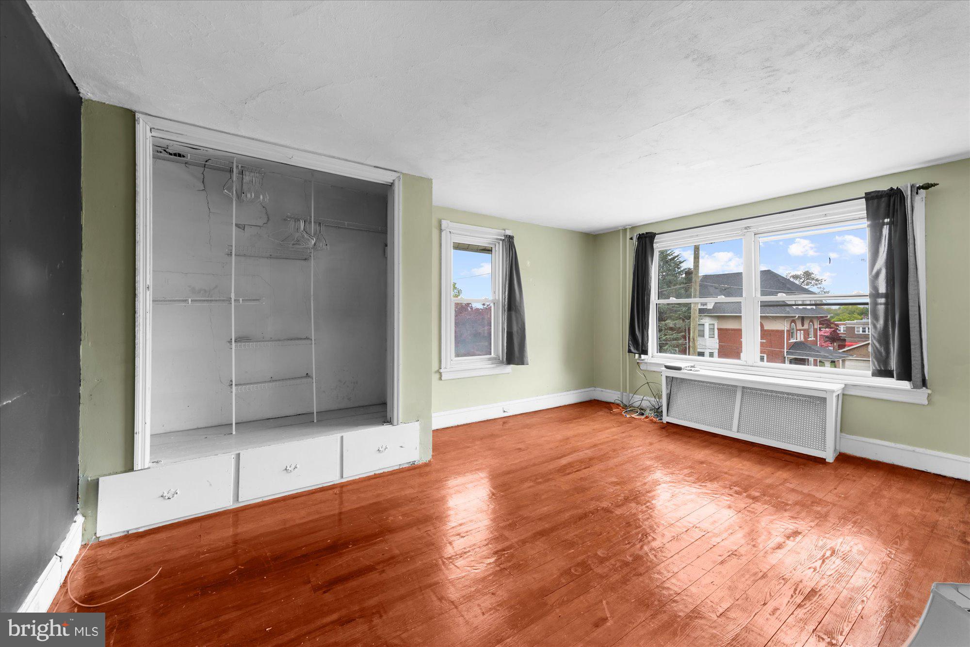 305 Lansdowne Road Havertown, PA 19083 - Photo 29 of 45 an empty room with wooden floor and windows