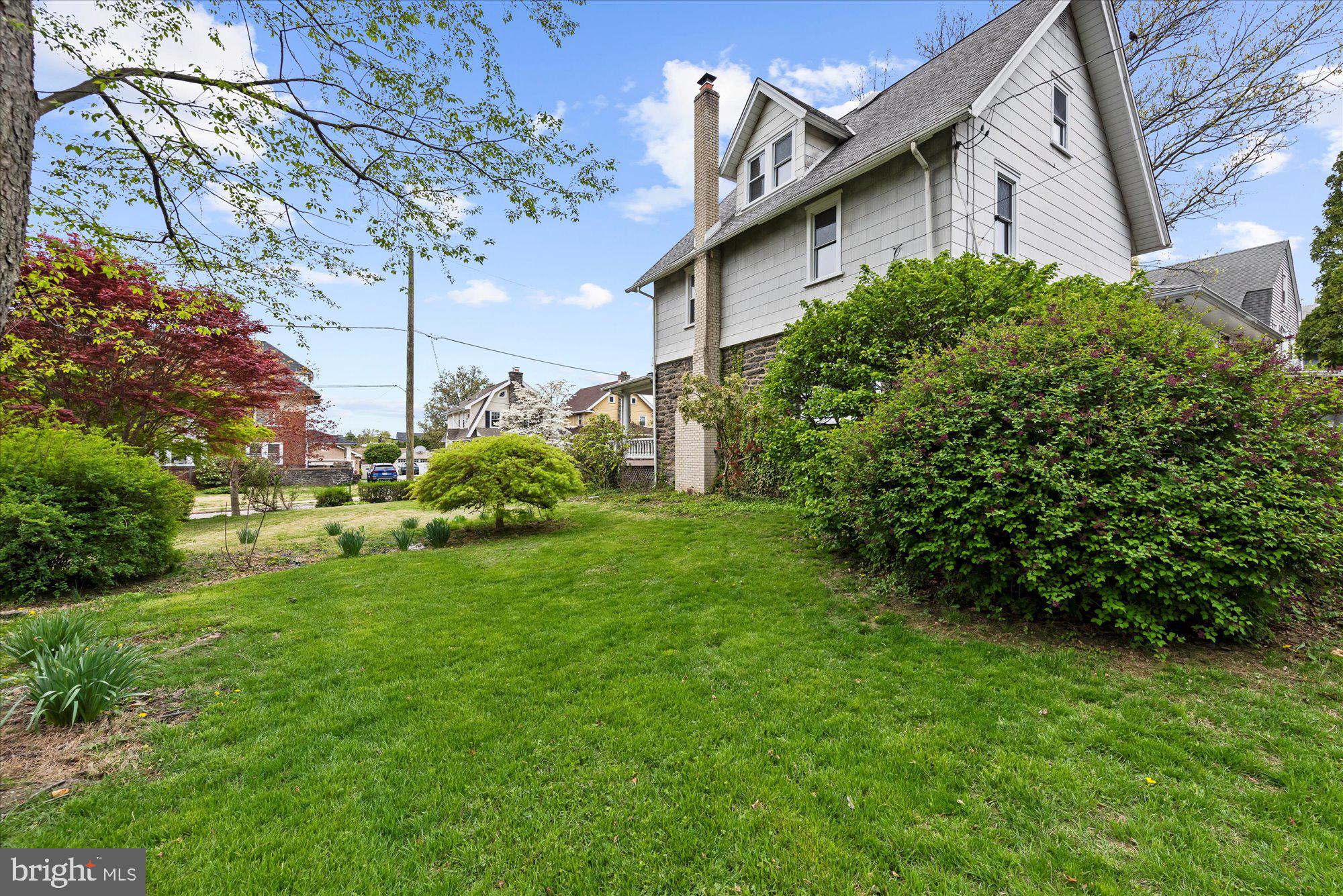 305 Lansdowne Road Havertown, PA 19083 - Photo 8 of 45 a view of a house with brick walls and a yard with plants
