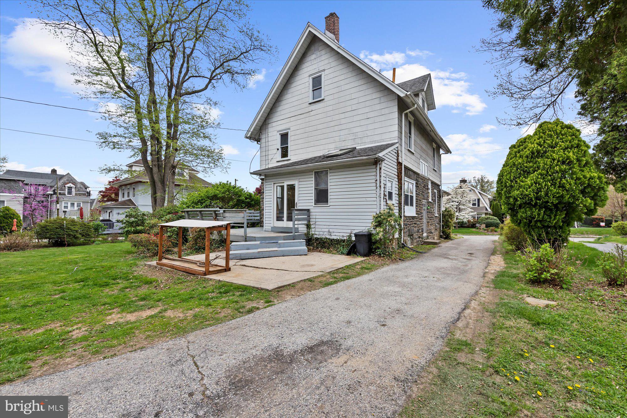 305 Lansdowne Road Havertown, PA 19083 - Photo 9 of 45 a front view of a house with garden and trees