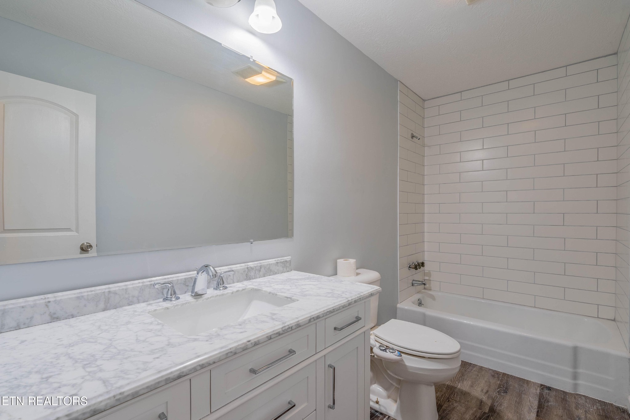 115 Manchester Road Oak Ridge, TN 37830 - Photo 14 of 22 a bathroom with a granite countertop sink a toilet and shower