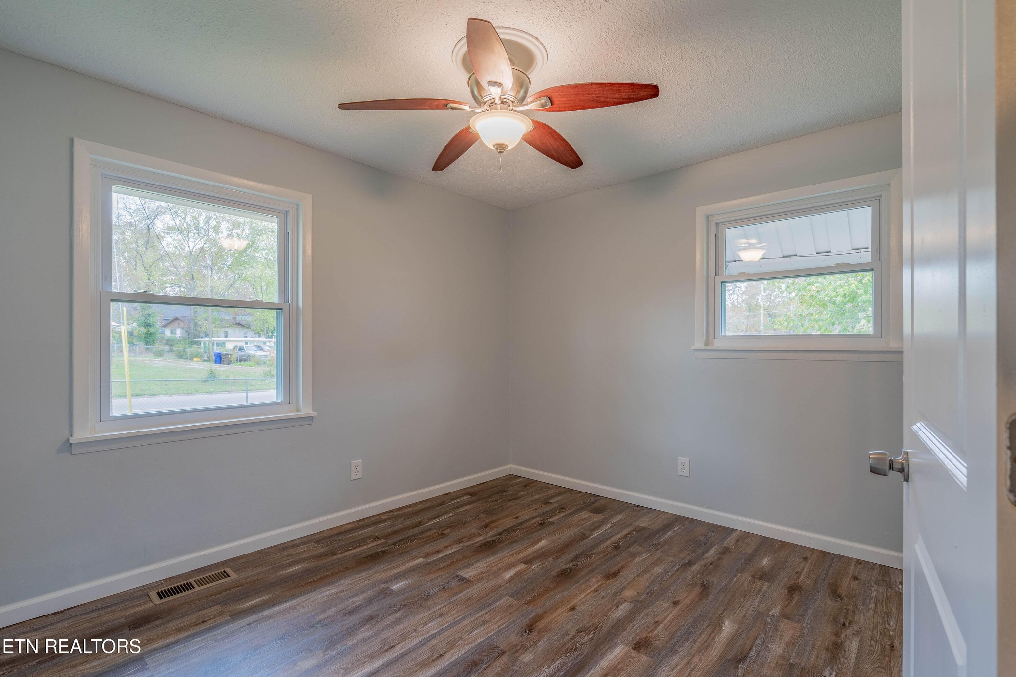115 Manchester Road Oak Ridge, TN 37830 - Photo 15 of 22 a view of an empty room with wooden floor and a window
