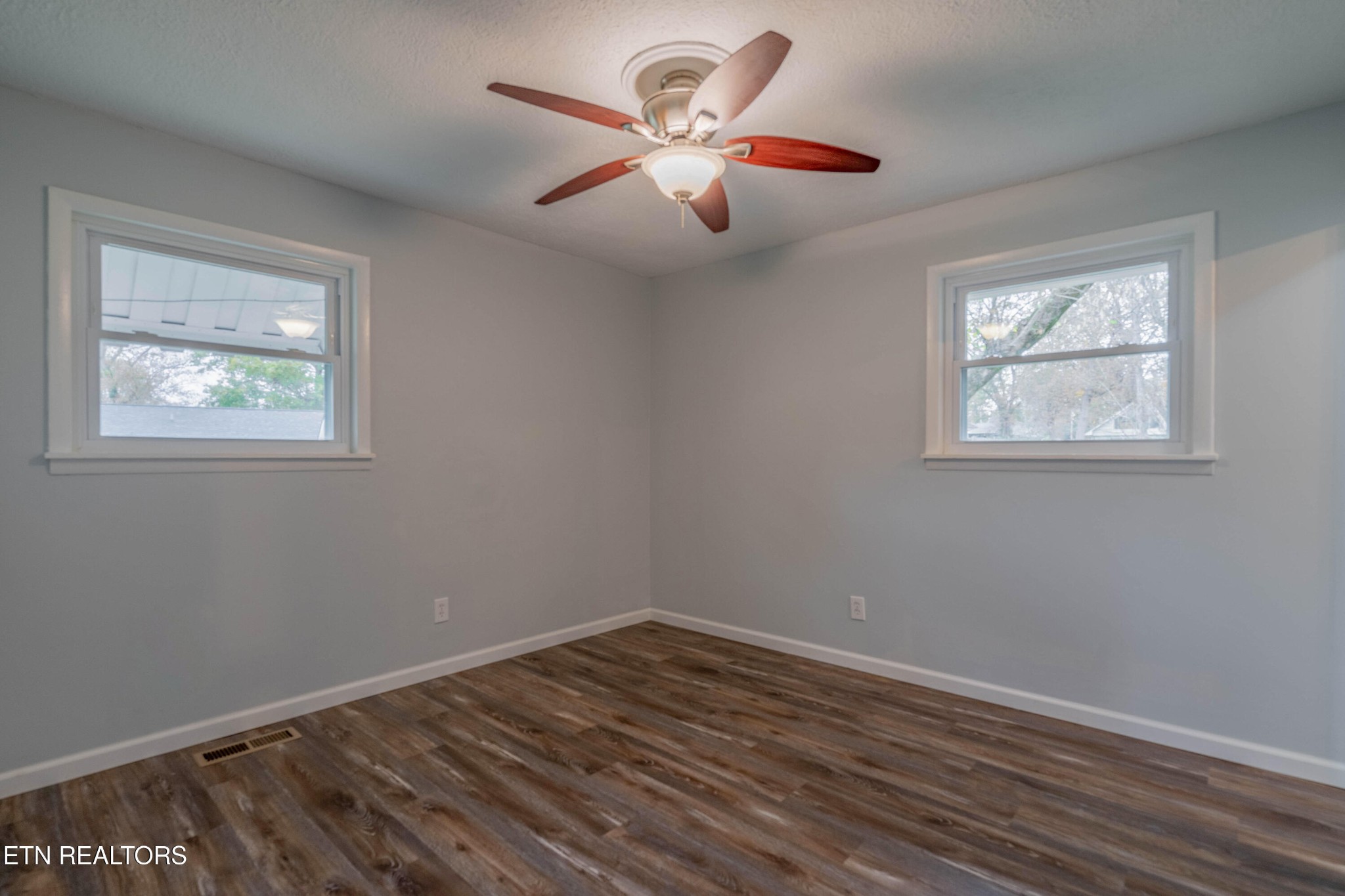 115 Manchester Road Oak Ridge, TN 37830 - Photo 17 of 22 a view of an empty room with wooden floor and a window