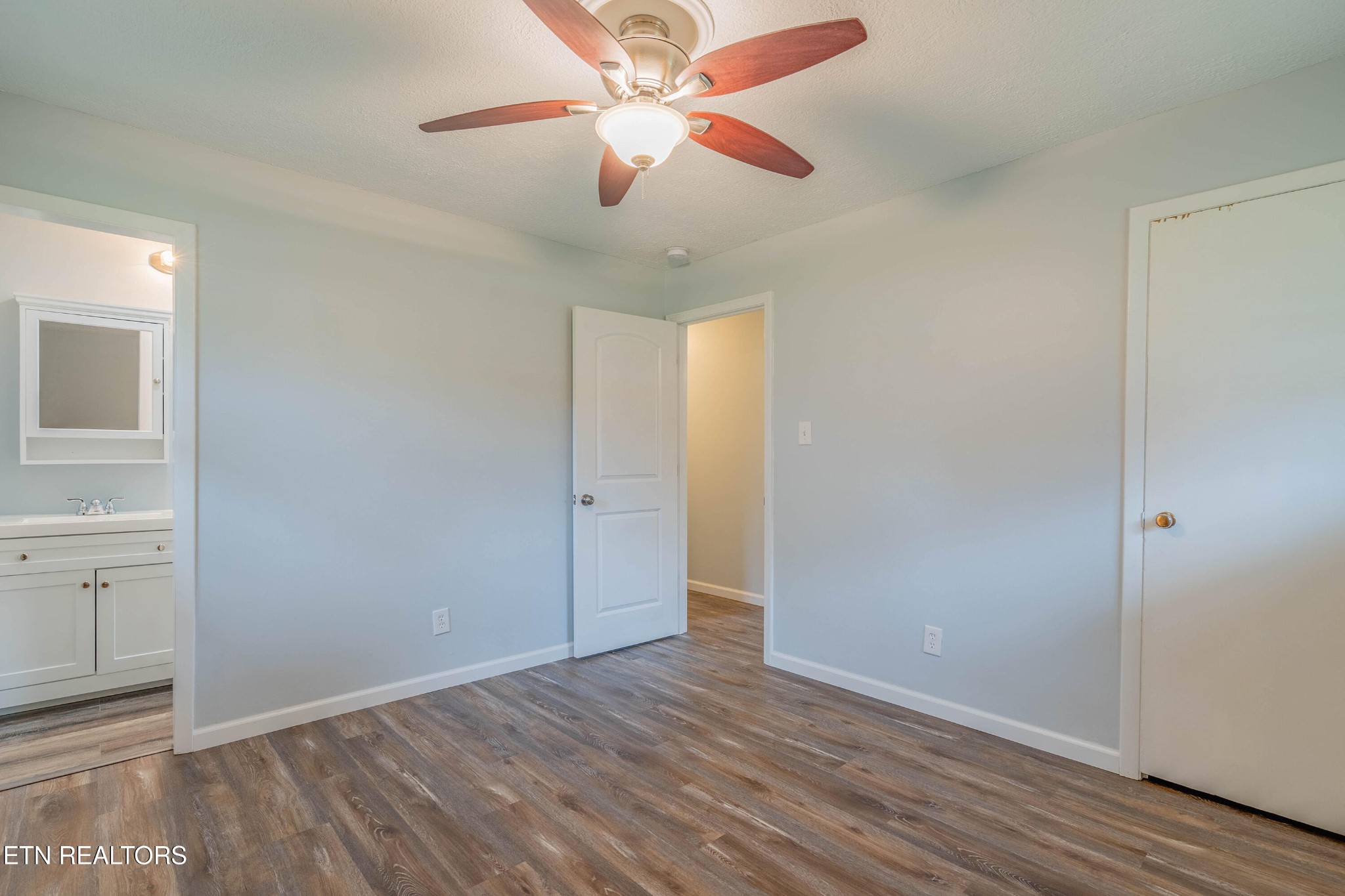 115 Manchester Road Oak Ridge, TN 37830 - Photo 18 of 22 wooden floor in an empty room with a chandelier fan