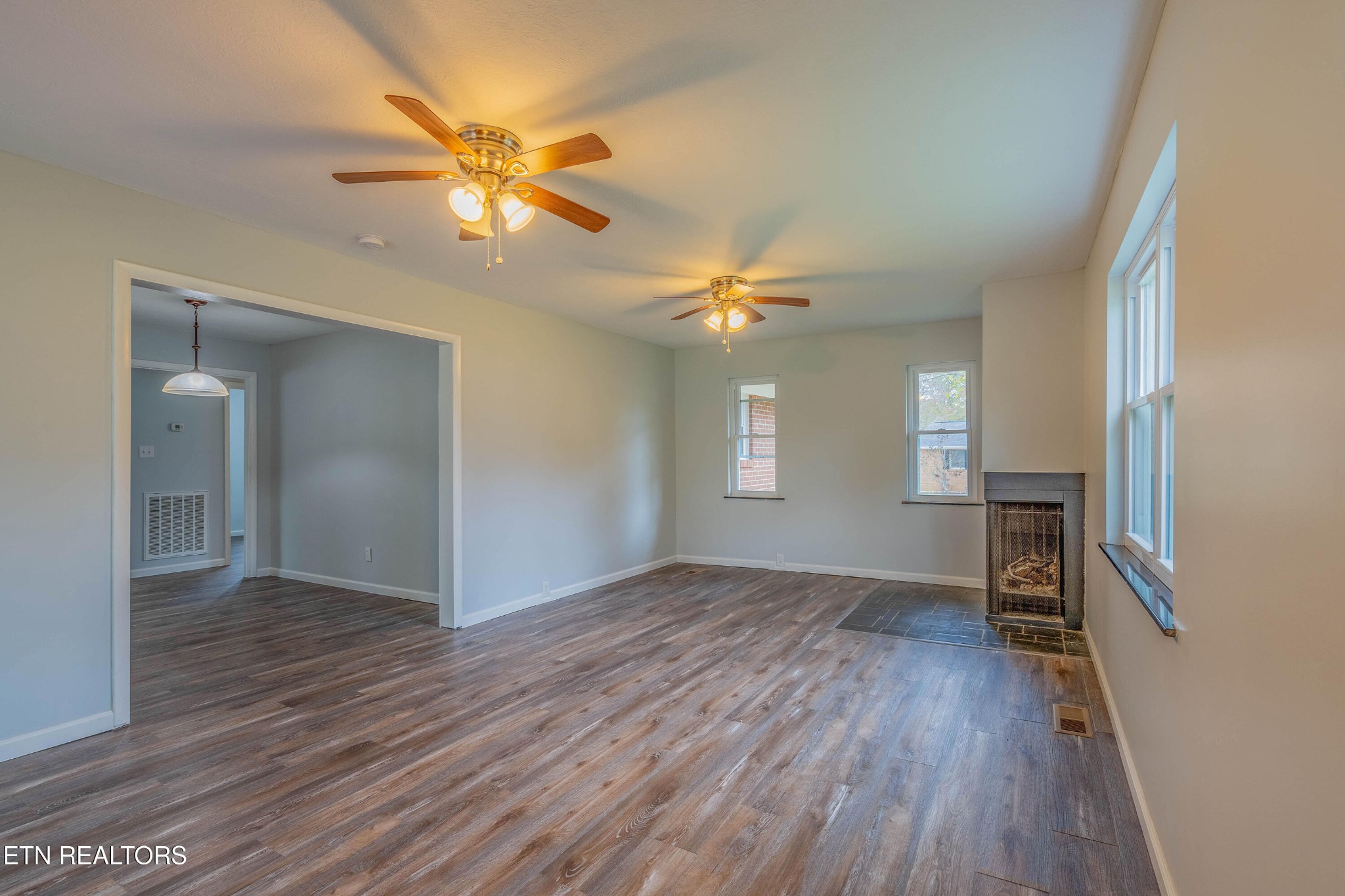 115 Manchester Road Oak Ridge, TN 37830 - Photo 8 of 22 wooden floor in an empty room with a window
