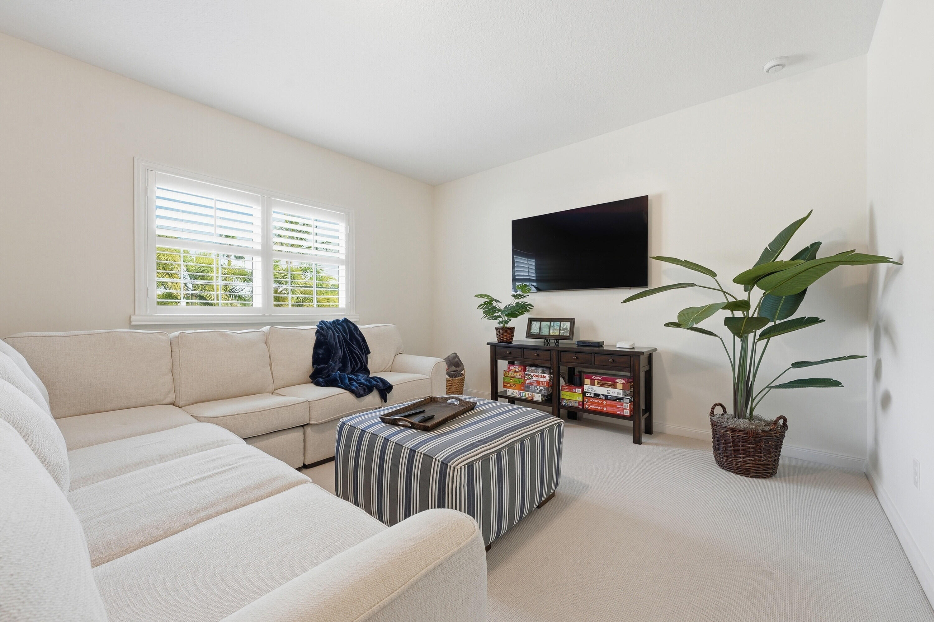 3443 South Caroline Street Jupiter, FL 33458 - Photo 25 of 60 a living room with furniture a flat screen tv and a large window