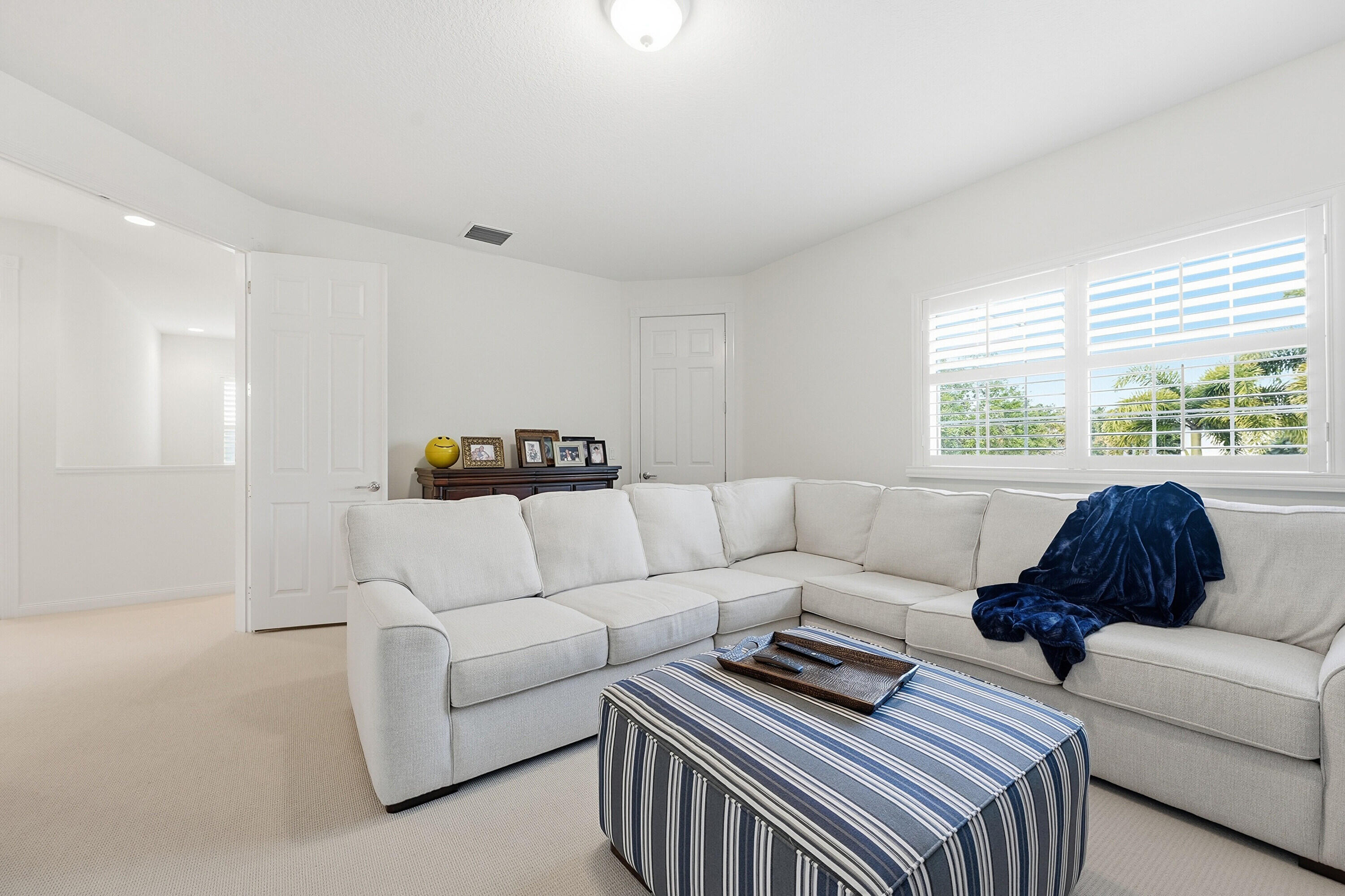 3443 South Caroline Street Jupiter, FL 33458 - Photo 26 of 60 a living room with furniture and a window