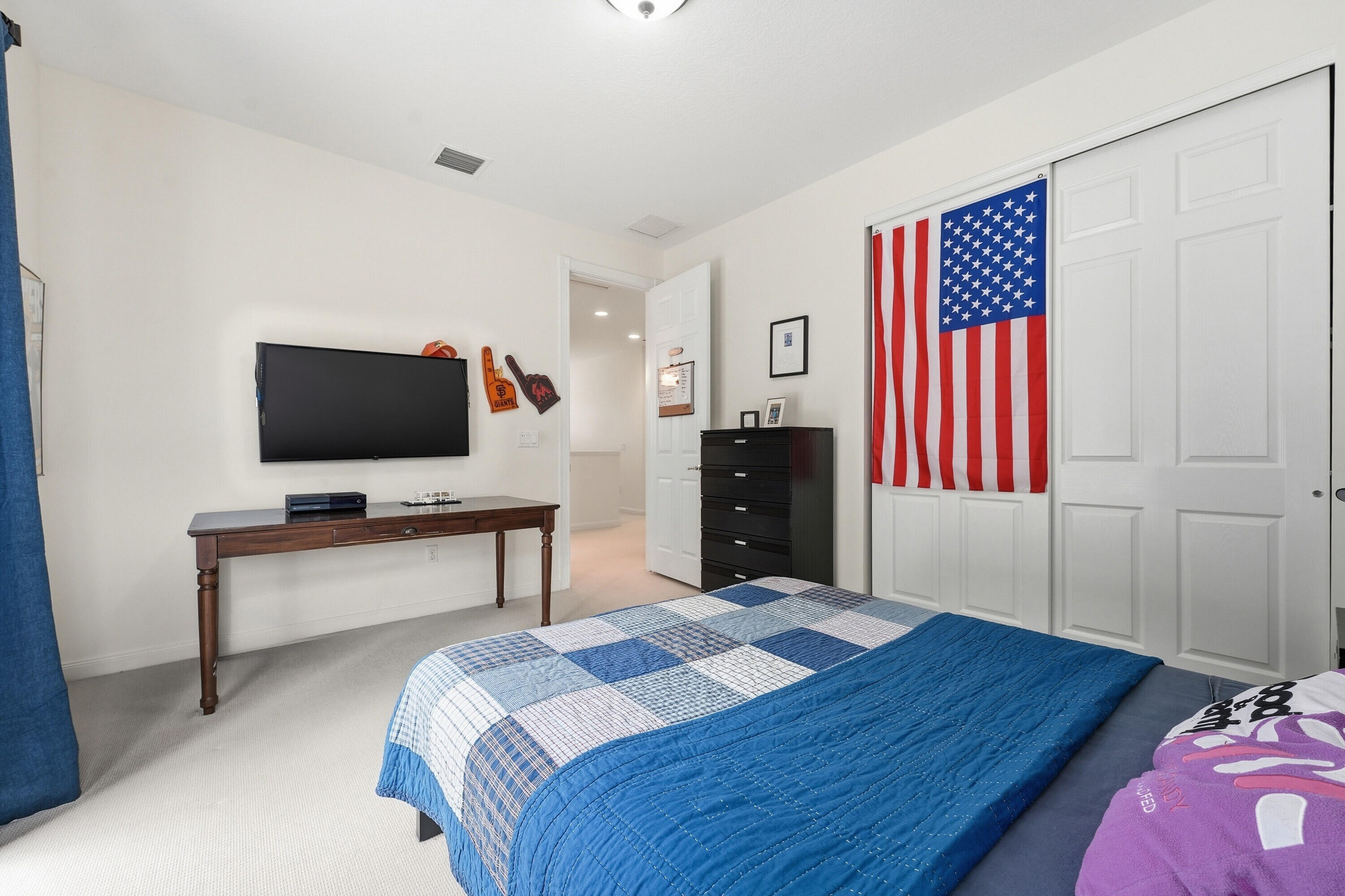 3443 South Caroline Street Jupiter, FL 33458 - Photo 28 of 60 a bedroom with a bed and a flat screen tv