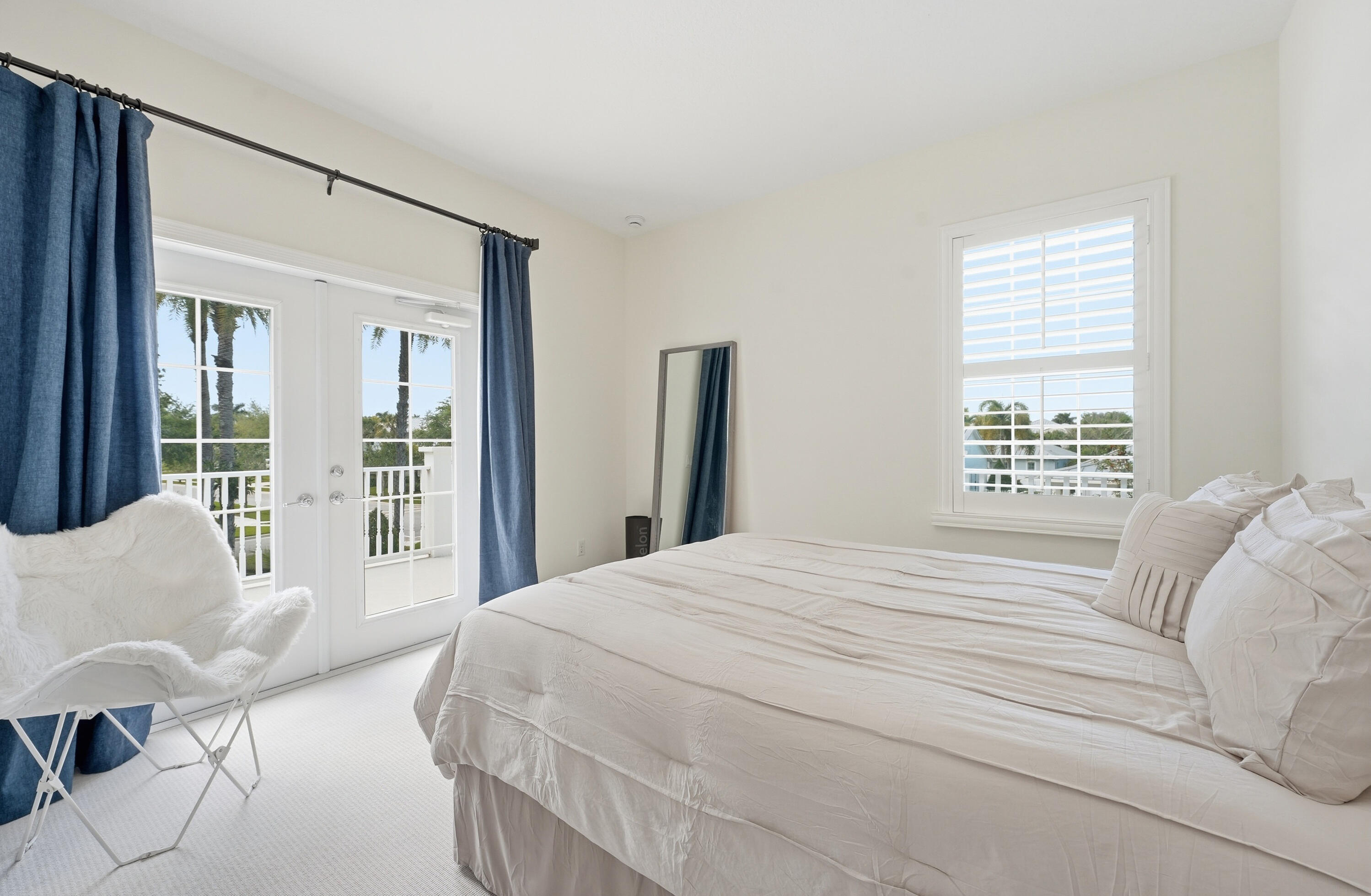 3443 South Caroline Street Jupiter, FL 33458 - Photo 29 of 60 a bedroom with a bed and glass window